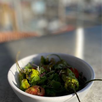 Palapa - a bowl of salad on a table - Bars Near Me - Long Beach, California Palapa - a bowl of salad on a table - Bars Near Me - Long Beach, California