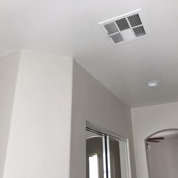The Crowning Touch - a bathroom with a ceiling fan - General Contractors Near Me