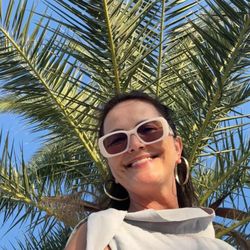 Dental Arts - Me smiling with my new smile under the palm tree, after dentist Atosa Khan's smile makeover