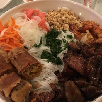 Sunset Phở Caffe - Number 18 - shrimp, grilled pork, egg roll, sitting on rice noodles with shredded lettuce and cucumber underneath. - Lounges Near Me - Chicago, Illinois