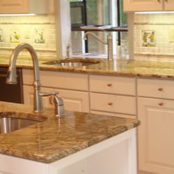 McMahon's Home Improvement - Custom cabinetry, golden granite and imported tile back splash.