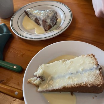 Le Petit Cafe - a slice of cheesecake with butter on a plate - French Near Me - Bloomington, Indiana