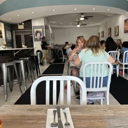 Carangi’s Cafe & Deli - Interior of restaurant. The bar with high seats is open to a walkway, not to a counter.