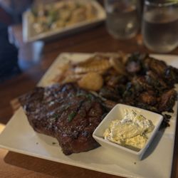 Rick's On Main - Bone in strip steak with truffle chip potatoes and Brussels