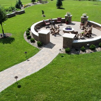 Lawn Pros - a circular fire pit surrounded by lawn furniture - Landscaping Near Me - Sergeant Bluff, Iowa