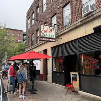 Sally's Apizza - Wooster street front. There is a separate line on left for dine in waiting and pickup which has its own section. - Pizza Near Me - New Haven, Connecticut Sally's Apizza - Wooster street front. There is a separate line on left for dine in waiting and pickup which has its own section. - Pizza Near Me - New Haven, Connecticut
