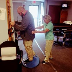 Crest Physical Therapy - Therapist working with patient on exercises.