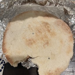 a half eaten sandwich on tin foil a half eaten sandwich on tin foil