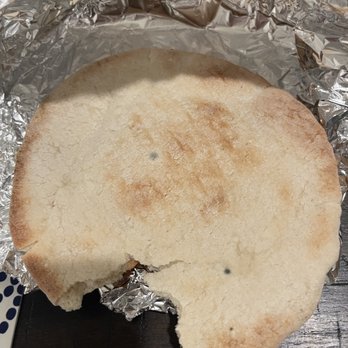 Kebab House - a half eaten sandwich on tin foil - Mediterranean Near Me - Orlando, Florida Kebab House - a half eaten sandwich on tin foil - Mediterranean Near Me - Orlando, Florida