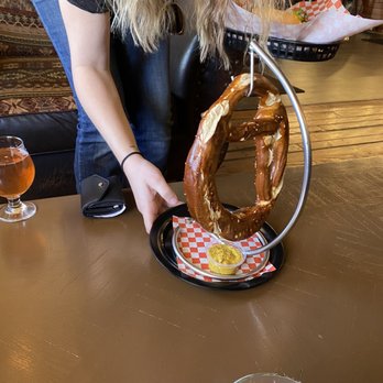 Brew Masters Deli - a woman holding a pretzel - Sandwiches Near Me - Foresthill, California