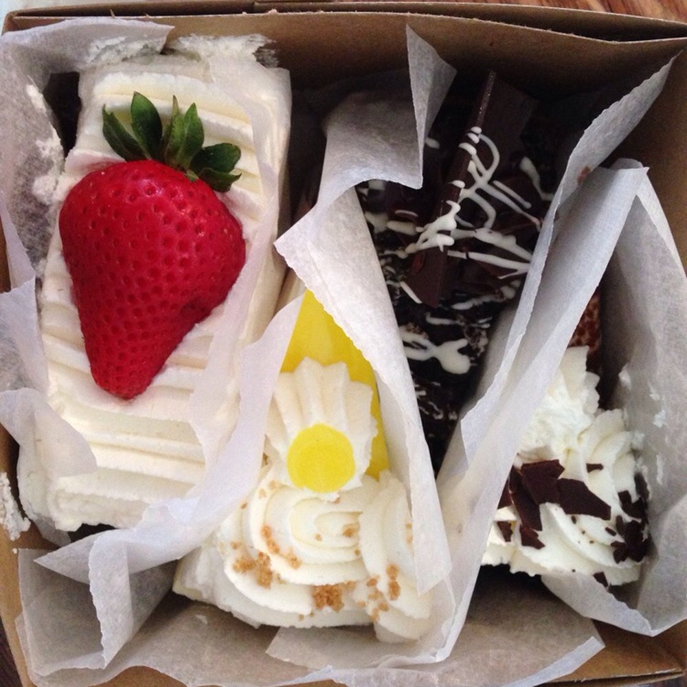 White's Bakery & Cafe - Potpourri of cake slices: lemon, strawberry shortcake, Oreo cheesecake, and tiramisu - Bakeries Near Me - Mansfield, Massachusetts