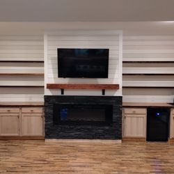 Finished fireplace, genstone facade, floating shelves, counter tops and mantle made from 100 year old reclaimed heart pine, Shiplap walls.
