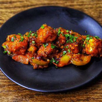 IST Snack Bar - a black plate of food on a wooden table - Indian Near Me - Toronto, Ontario