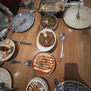 Saffron - From bottom to top-  Saffrons Daal Makhani Saffon's Famous Butter Chicken Seasonal Vegetable Masala Traditional Lamb Curry Garlic Naan - Indian Near Me - San Carlos, California