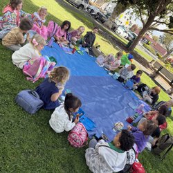 Luna's Montessori Bilingual School - Children enjoying a picnic together during one of our fun summer camp outings.