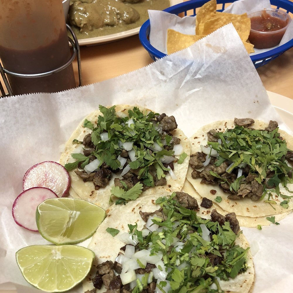 three tacos on a table three tacos on a table