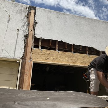 Joy Construction - a man working on a roof - General Contractors Near Me