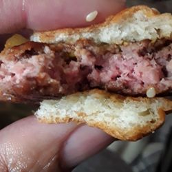 McDonald's - This is my quarter pounder with cheese...but they gave me no cheese. This burger was still pink in the middle...no happy at all!