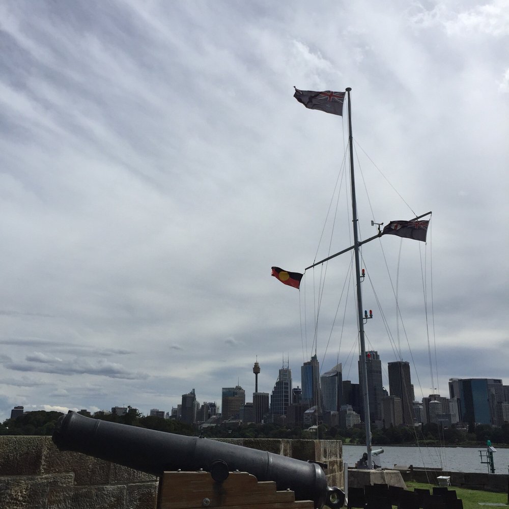 Fort Denison - Flags flying high on their pole with the City in the background, overlooking the 8" cannon aimed at Rose Bay. - Landmarks & Historical Buildings Near Me