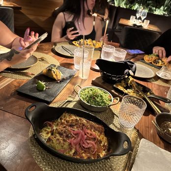 Toca Madera - Enchiladas and birthday girl in the back - Steakhouses Near Me - Houston, Texas