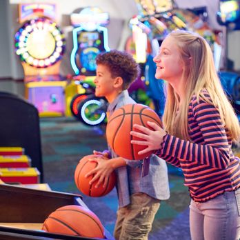 Chuck E. Cheese - a boy and a girl holding basketballs - Pizza Near Me - Tupelo, Mississippi