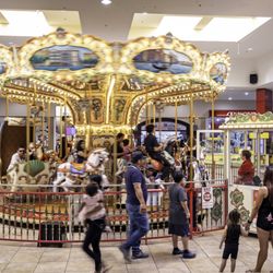 Desert Sky Mall - Families gather around a brightly lit carousel inside Desert Sky Mall.