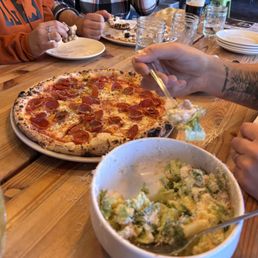 Pepperoni pizza and Cesar salad Pepperoni pizza and Cesar salad