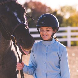 Grit & Grace Ranch - Saphira and Megan having a laugh together in the outdoor arena after a riding lesson.