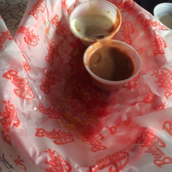 Bubba's 33 - A half order of onion rings, showing the literal quarter inch of oil in the wax paper liner. - Pizza Near Me - Colorado Springs, Colorado