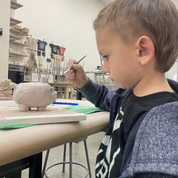 Mud Hut Pottery Studio - painting his pig - Art Classes Near Me - Riverside, California Mud Hut Pottery Studio - painting his pig - Art Classes Near Me - Riverside, California