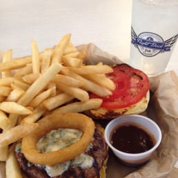 a burger with onion rings and a side of fries a burger with onion rings and a side of fries