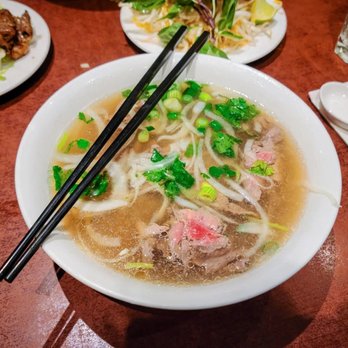 Pho Ngon - a bowl of soup with chopsticks - Vietnamese Near Me - Montreal, Quebec