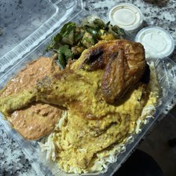 Lemon garlic chicken plate with spicy hummus and veggie salad over rice Lemon garlic chicken plate with spicy hummus and veggie salad over rice
