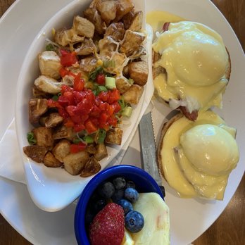 Breakfast at Tiffany's - Eggs Benedict with cup of fruit and potatoes with peppers and green onions - Breakfast & Brunch Near Me - Kalamazoo, Michigan