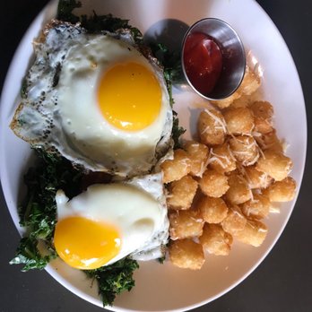 Cazzy's Corner Grill - Salmon cakes with kale, sunny side eggs, and mornay sauce. Side of duck fat tots. - American Near Me - Knoxville, Tennessee Cazzy's Corner Grill - Salmon cakes with kale, sunny side eggs, and mornay sauce. Side of duck fat tots. - American Near Me - Knoxville, Tennessee