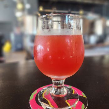 Black Flamingo - a drink in a glass on a coaster - Breweries Near Me - Oakland Park, Florida Black Flamingo - a drink in a glass on a coaster - Breweries Near Me - Oakland Park, Florida