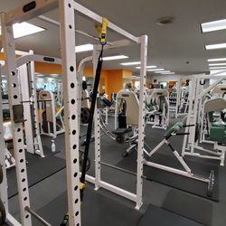 Downtown Fitness Center - Power rack, Smith machine, and various Nautilus machines.