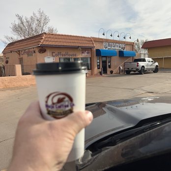 Mojo Coffee Co - a hand holding a cup of coffee - Coffee & Tea Near Me - Winslow, Arizona Mojo Coffee Co - a hand holding a cup of coffee - Coffee & Tea Near Me - Winslow, Arizona