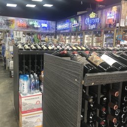 rows of wine bottles in a liquor store