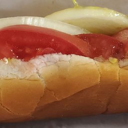 a hot dog with tomatoes and pickles a hot dog with tomatoes and pickles