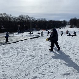 The unattended magic carpet lift, with sad skiers using it to walk uphill. The unattended magic carpet lift, with sad skiers using it to walk uphill.