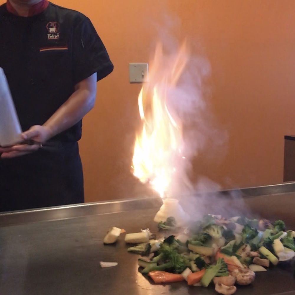 The chef cooking onions in the shape of a volcano The chef cooking onions in the shape of a volcano