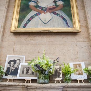 Blooms in Bunches - Mantle with family wedding photos and small arrangements. - Florists Near Me - Merrick, New York