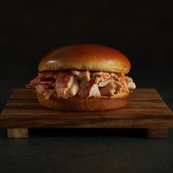 Sandwich Affair - a chicken sandwich on a wooden board - Sandwiches Near Me - Miami, Florida