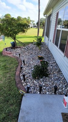 The Great Outdoors - Removal of plants and shrubs and replacement of rock.  Ground cleanup.
