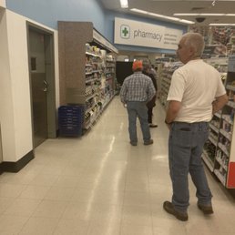 two men walking down the aisle of a store two men walking down the aisle of a store