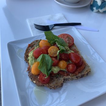 Grinder’s Coffee Bar - All the tomatoes toast with avocado spread - Coffee & Tea Near Me - Houston, Texas