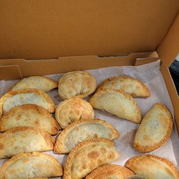an open box of empanadas an open box of empanadas