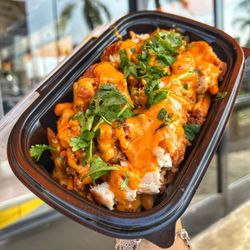 Egg N Bird - Dirty Fries made with Seasoned Fries topped with Chopped Chicken, Cilantro, Nacho Cheese, and Drizzled with Crack Sauce