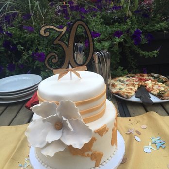 Get Caked - Keep in mind the yellow table cloth was provided by restaurant to match cake. Sigh. The color I expected was of the cake topper. - Bakeries Near Me - Rochester, New York